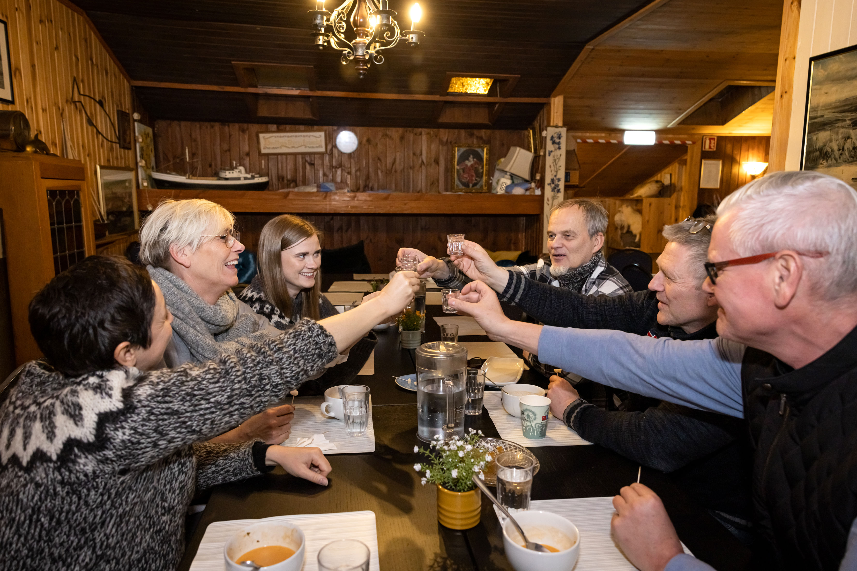 A group of travelers having a toast together while enjoy themselves on the food tour.