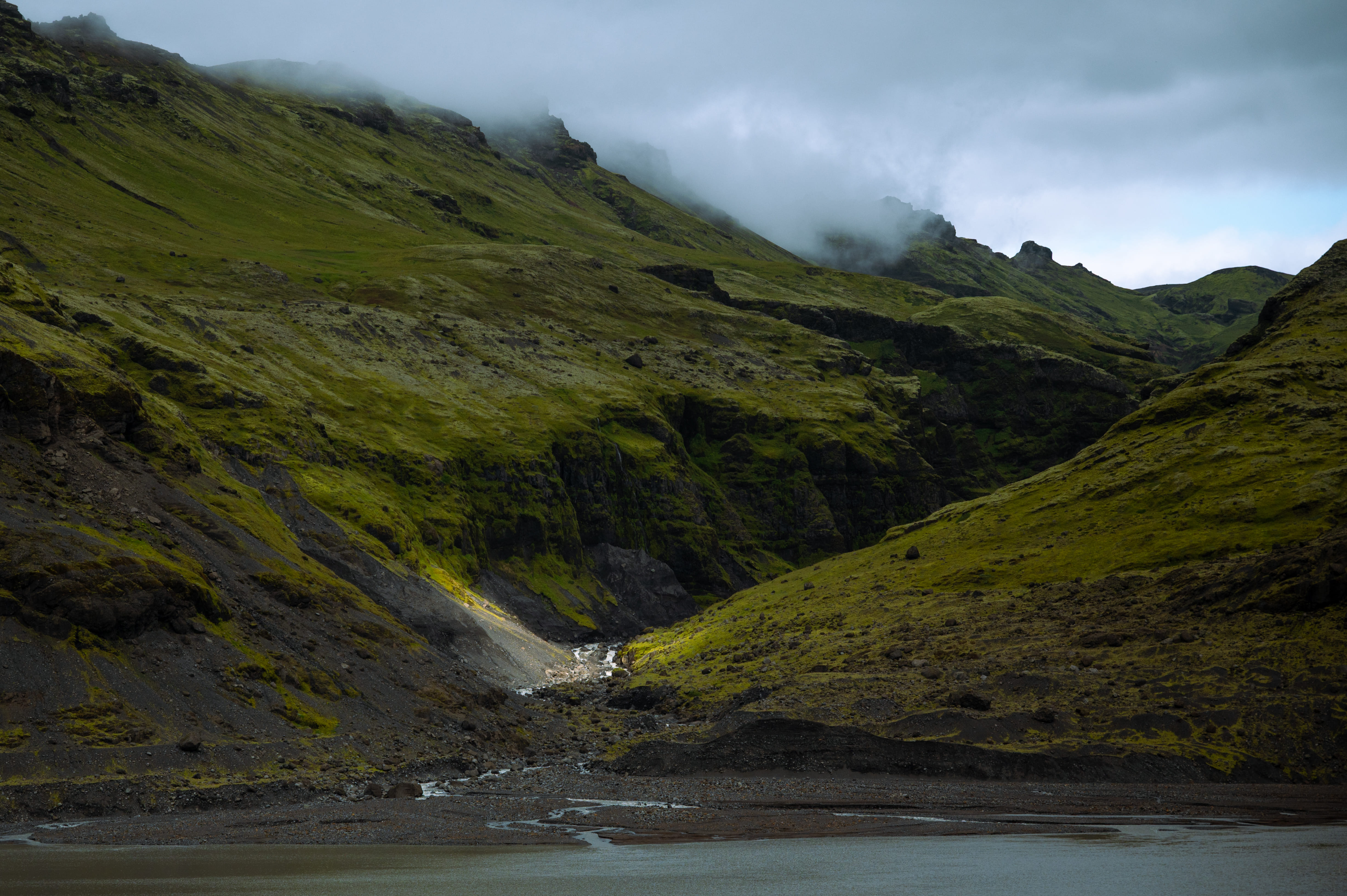 Misty moss-covered volcanic slopes typical of the Icelandic South Coast region
