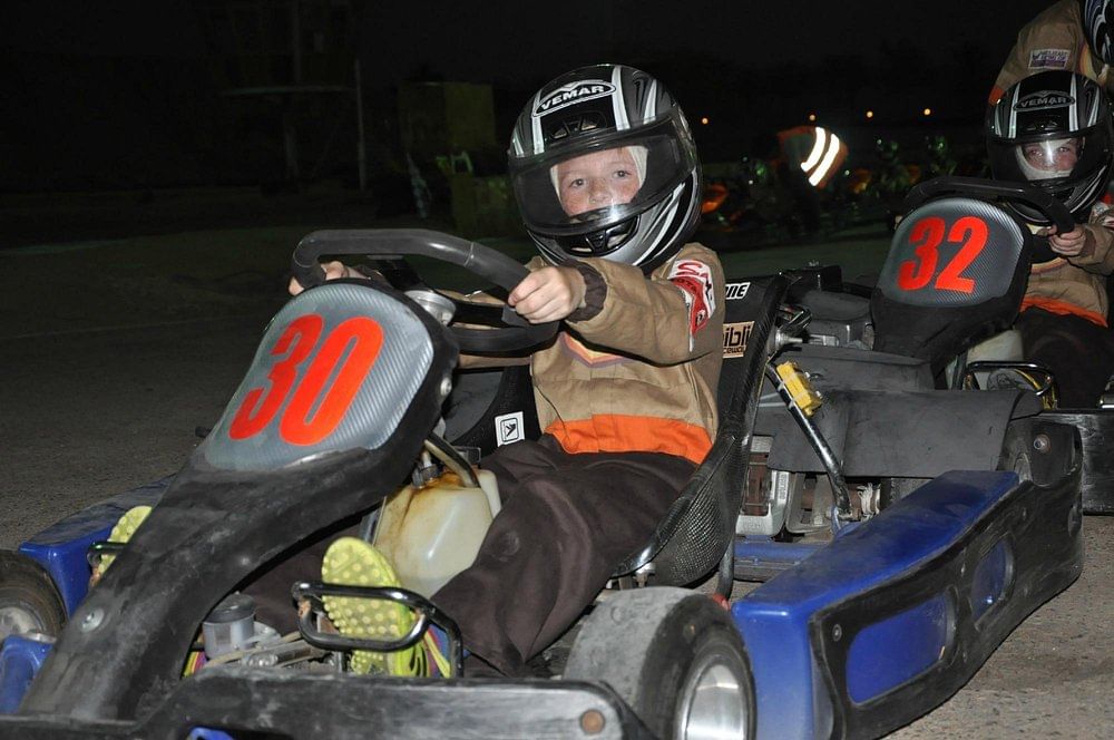 Participants receiving safety gear and a briefing before their go-karting session at Ghibli Raceway.