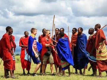 Guests participating in a traditional Maasai welcome dance in Tanzania.