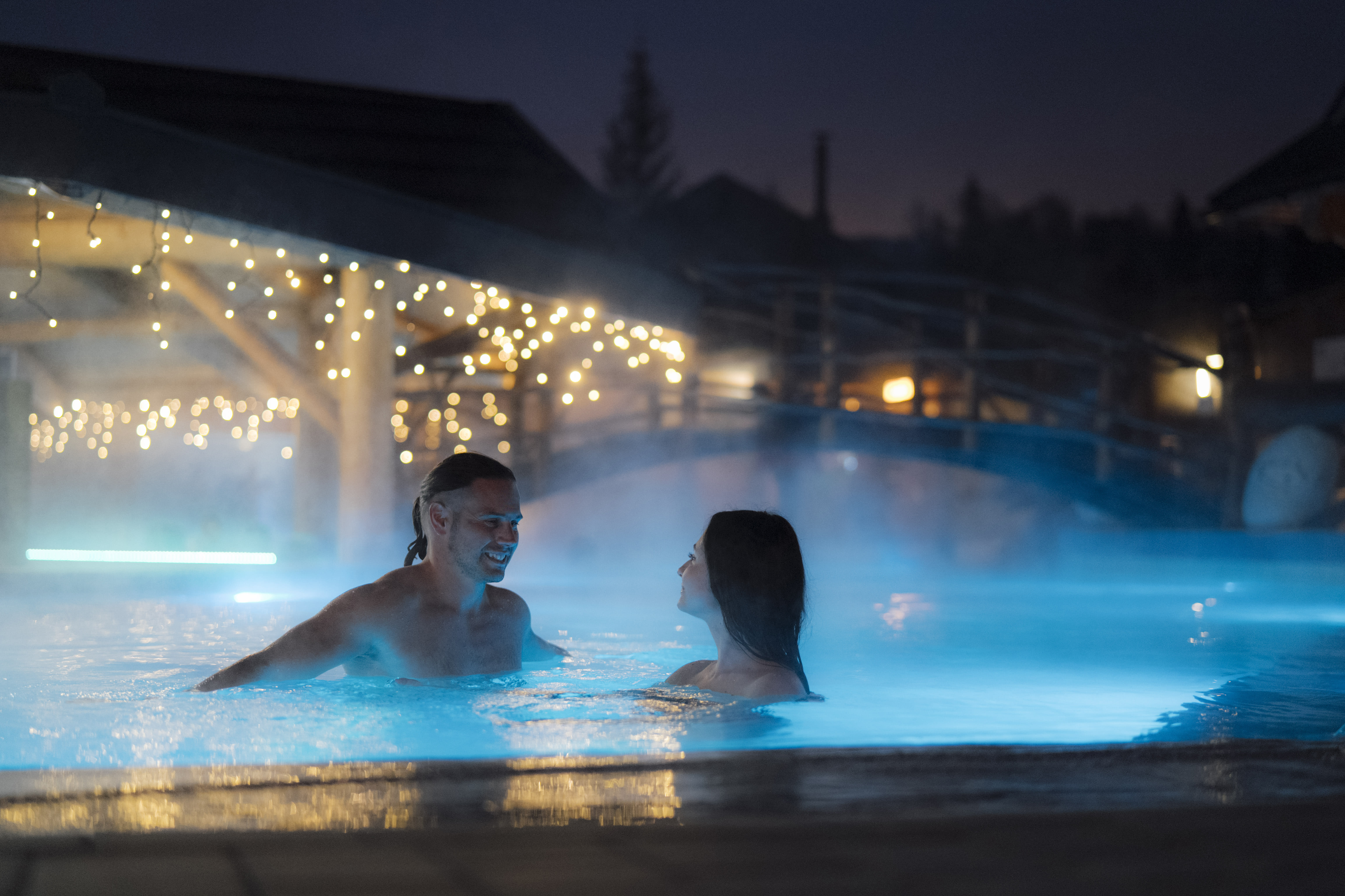Gorący Potok thermal pool evening atmosphere — couple relaxing in sulphur water Szaflary