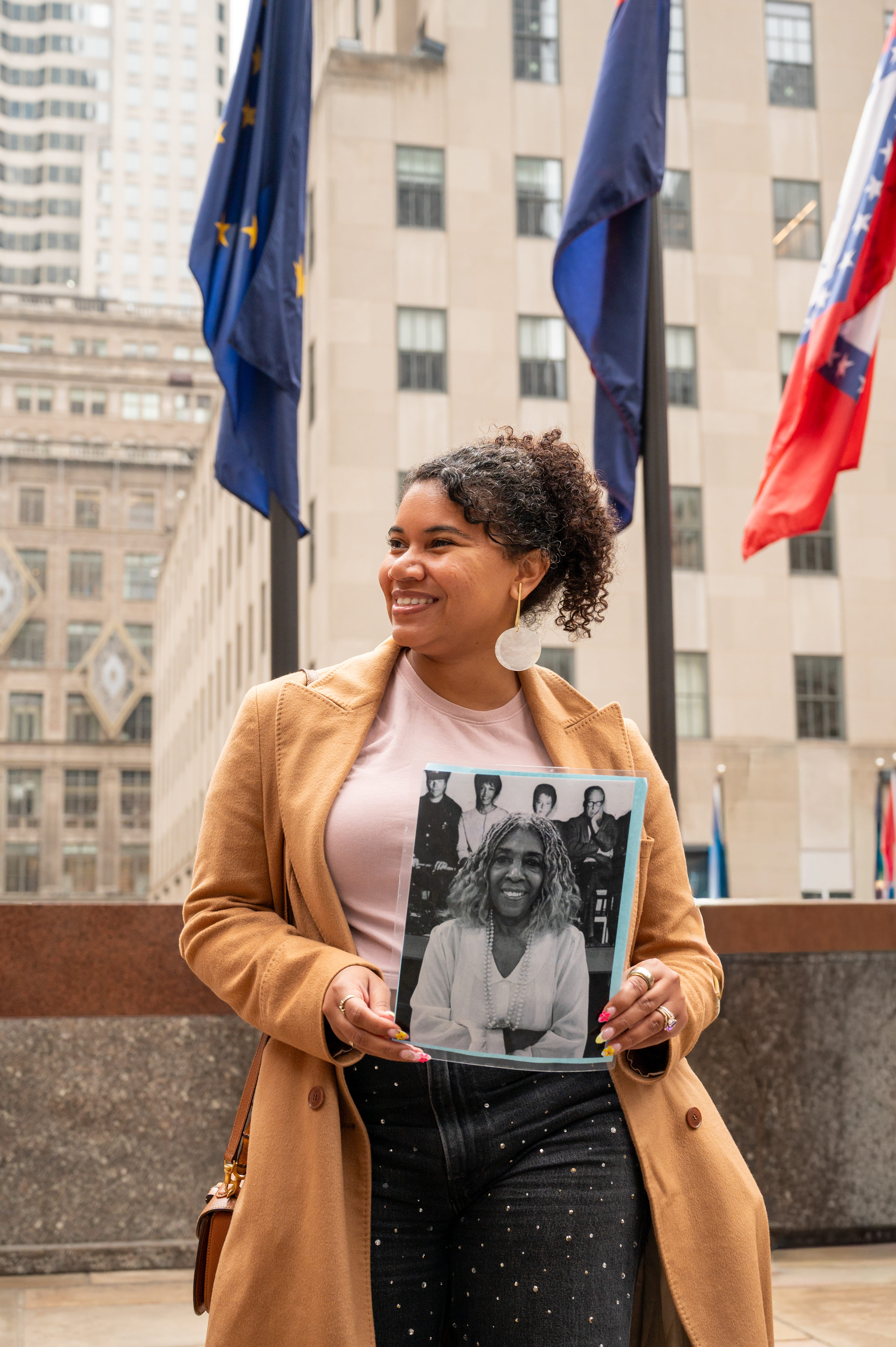 A guest holds up a picture of the fashion-designer turned off-off-broadway producer.