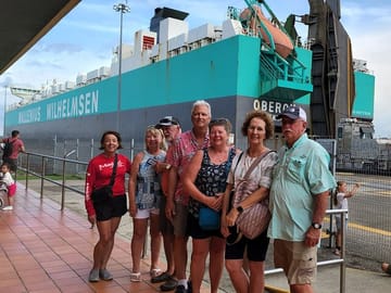 Tourists watching a boat pass through the Panama Canal in the locks of Miraflores