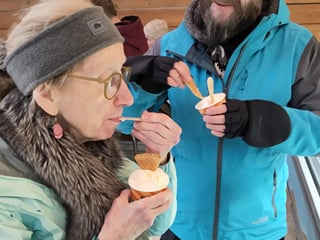 A traveller enjoying a cup of Ice Cream.