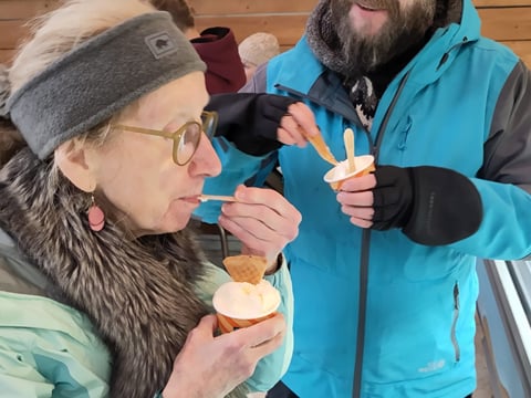 A traveller enjoying a cup of Ice Cream.