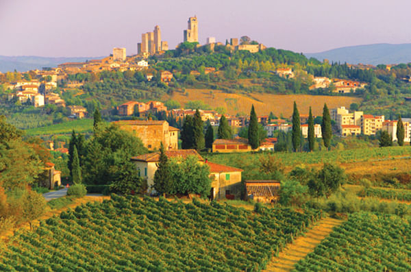 Panoramic view of the Tuscan countryside with San Gimignano in the background