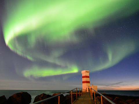 The northern lights over the Lighthouse in Gardur, located in southwest Iceland