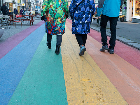 A group of travellers walking down the Rainbow Street in downtown Reykjavik