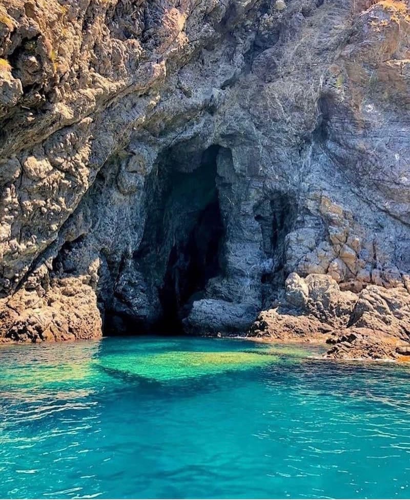Crystal-clear waters inside a natural sea cave along the Costa Viola