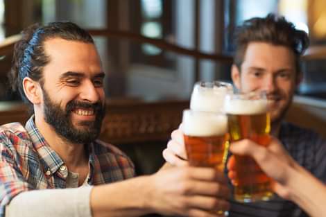 Two men saying cheers to being in Reykjavík Iceland.