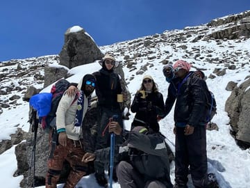 Celebrating milestones together—our professional guides ensure every step toward the summit is safe and memorable.