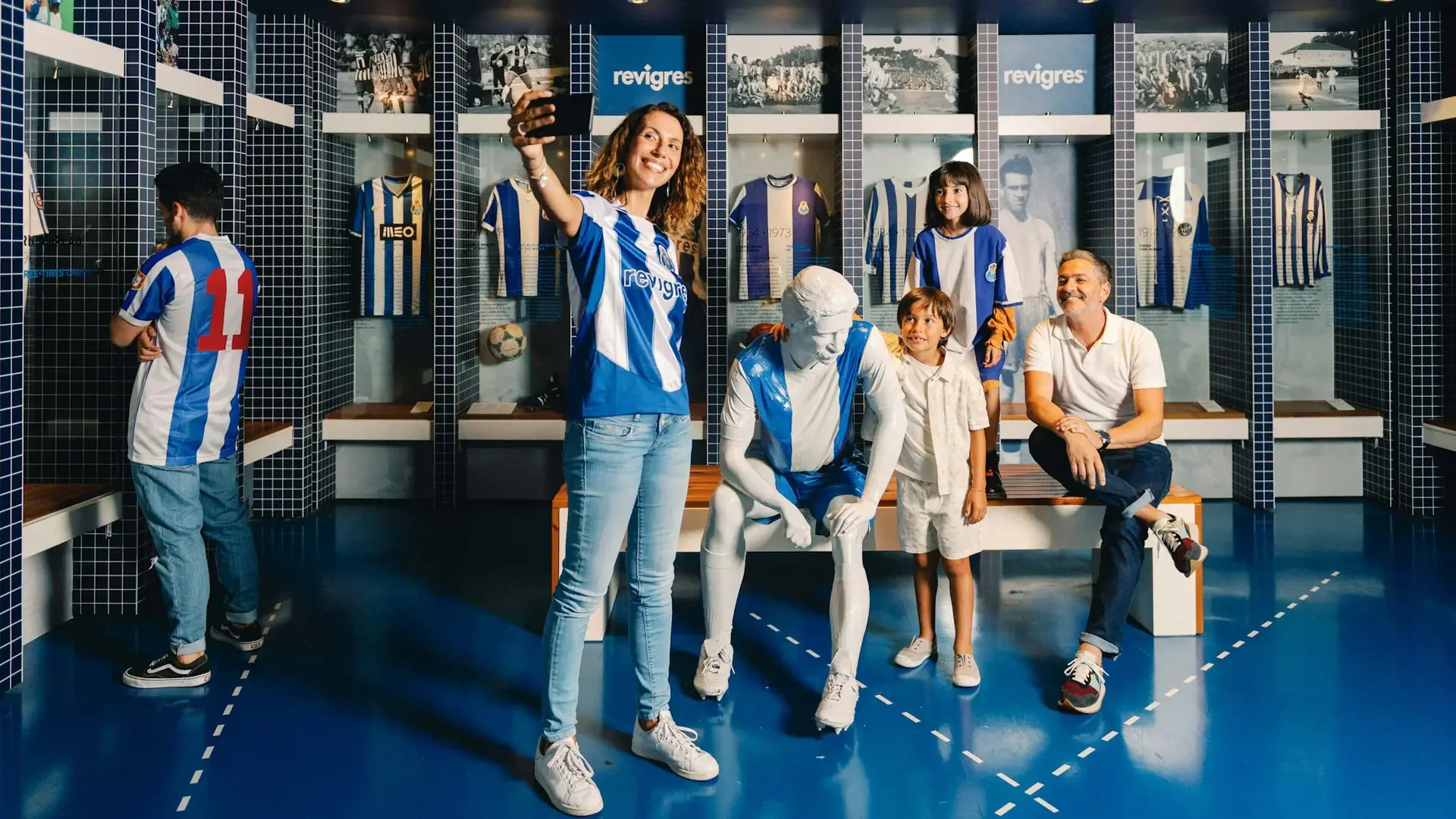 A family poses together inside a sports museum with vintage jerseys on display at FC Porto Museum & Dragão Stadium ticket.