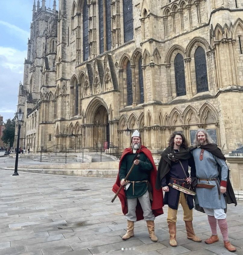 Three viking men stood in front of York Minster.
