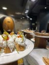 Snack in fron of the photo, in the back a big oak barrel