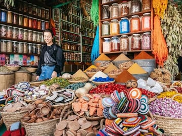 A colorful scene inside the souks of Marrakech, where your local guide leads you through narrow alleys filled with Moroccan crafts and vibrant textiles — a truly authentic Marrakech experience.