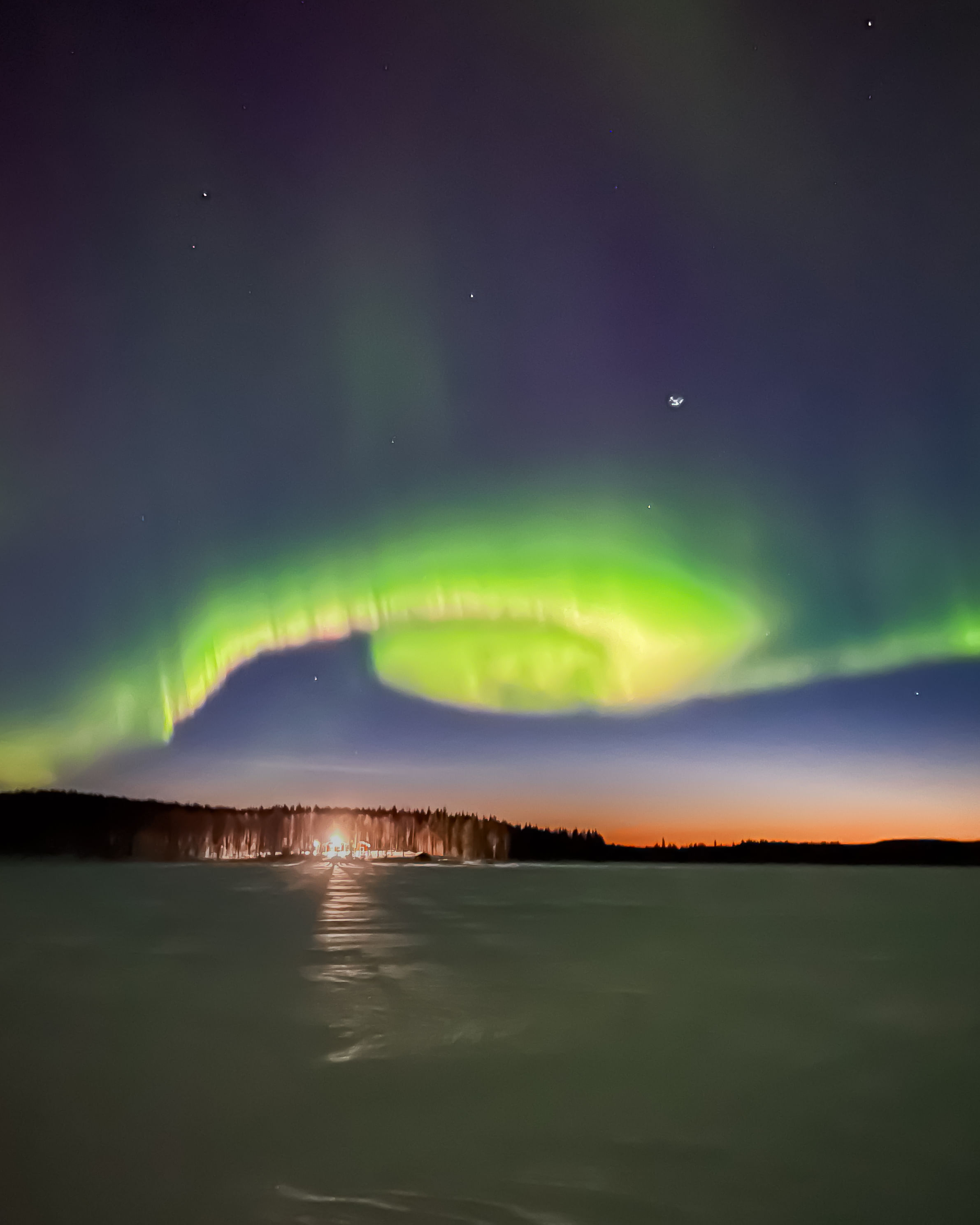 Snowmobiles riding through the snowy wilderness of Rovaniemi during StayLapland’s Northern Lights Tour Snowmobile Driving.