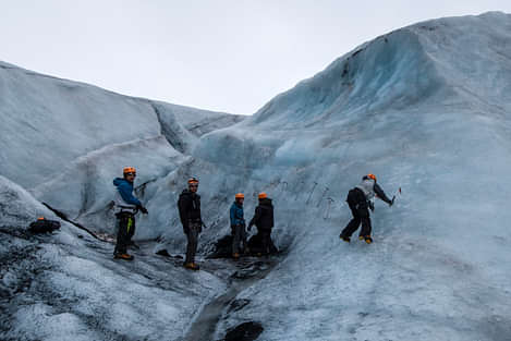 People hiking and climbing on a glacier