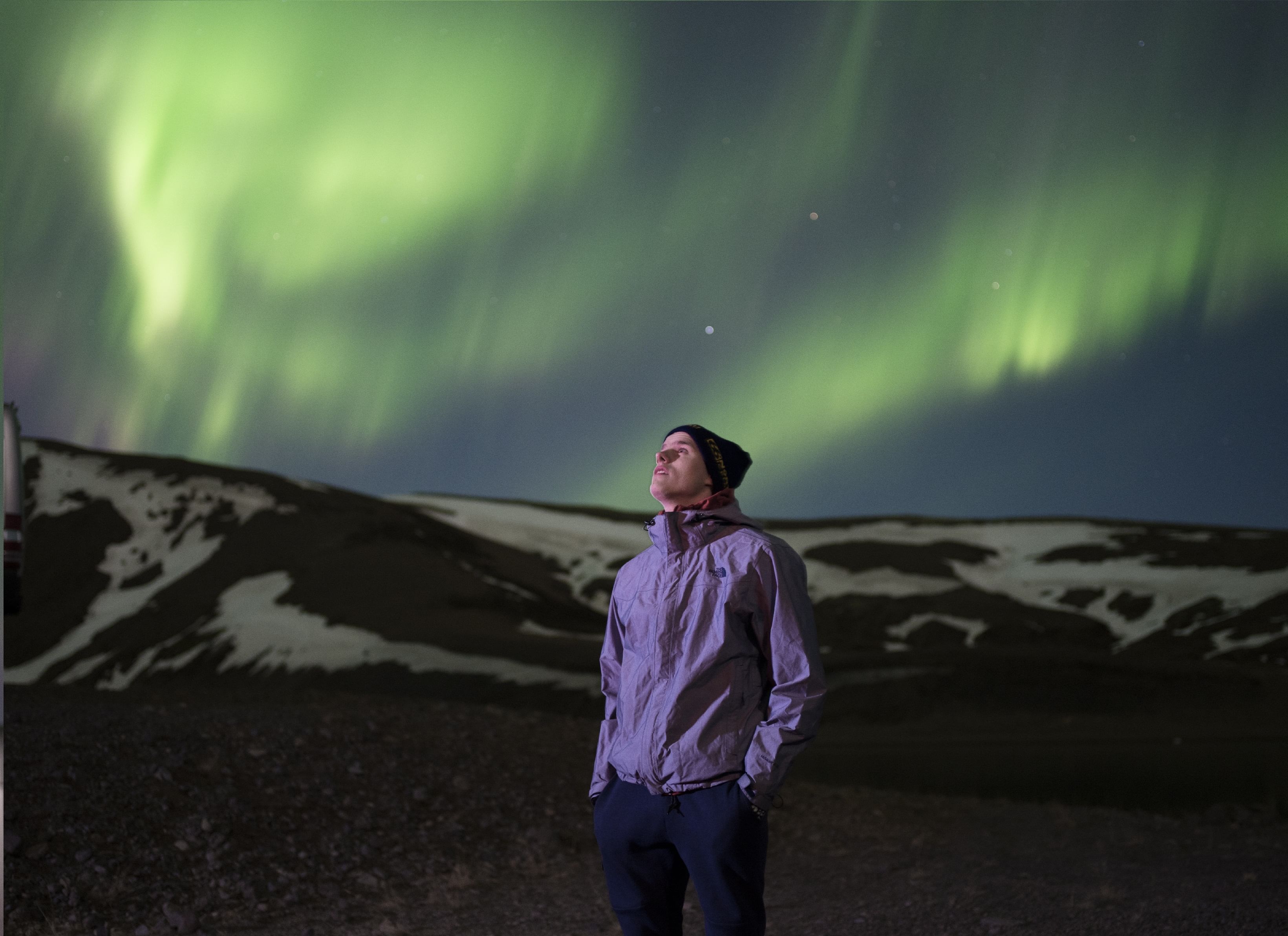 A man enjoying the Northern lights during Northern lights jeep tour Iceland