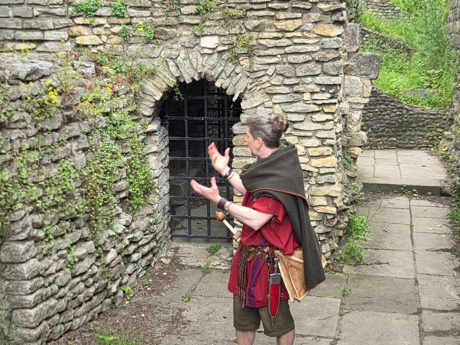 The Original Roman Walk's guide, dressed as a Roman legionary, in front of the Anglian Tower, in the Museum Gardens, York.
