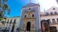 Misericórdia Church in Aveiro with blue azulejo facade, stone portal, and cross