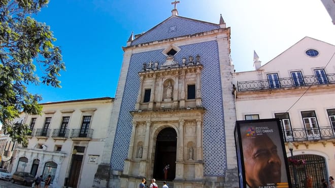 Misericórdia Church in Aveiro with blue azulejo facade, stone portal, and cross