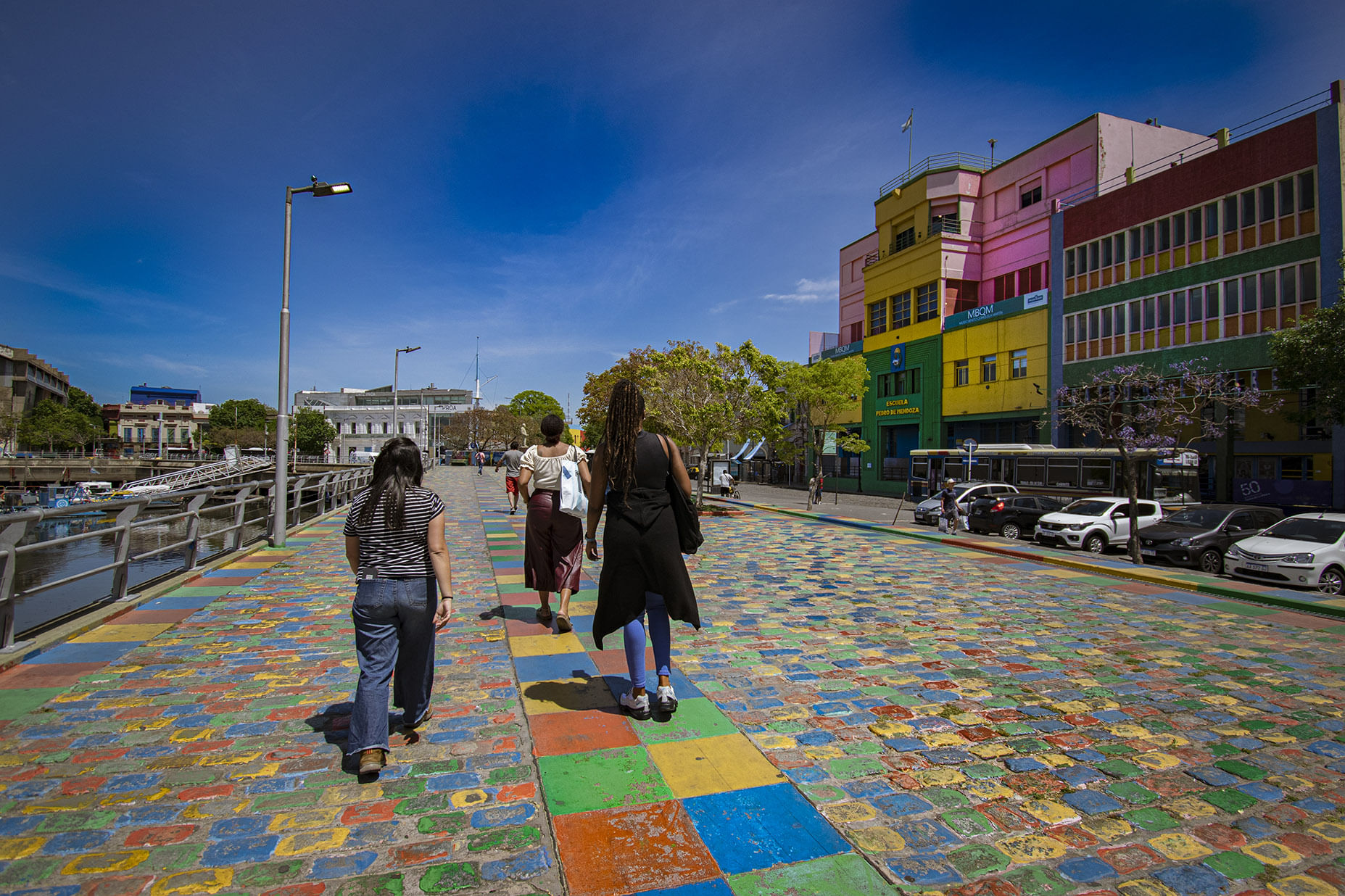 People walking on the colored paveway of La Boca