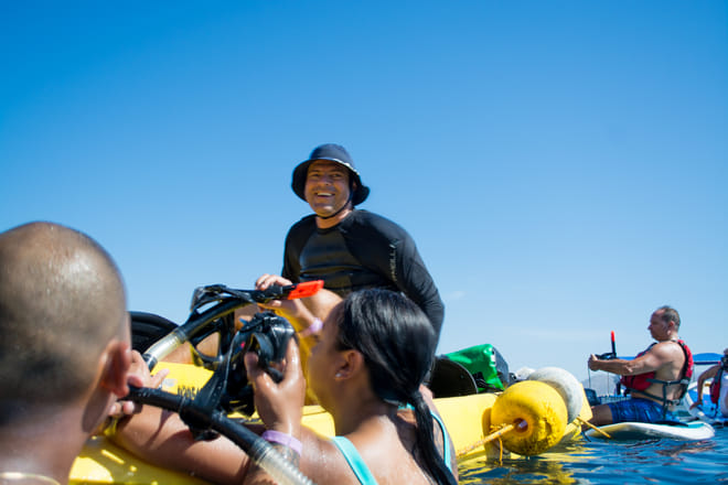 Group preparing to snorkel during kayak tour los cabos sea of cortez people with snorkel gear near kayaks cabo san lucas