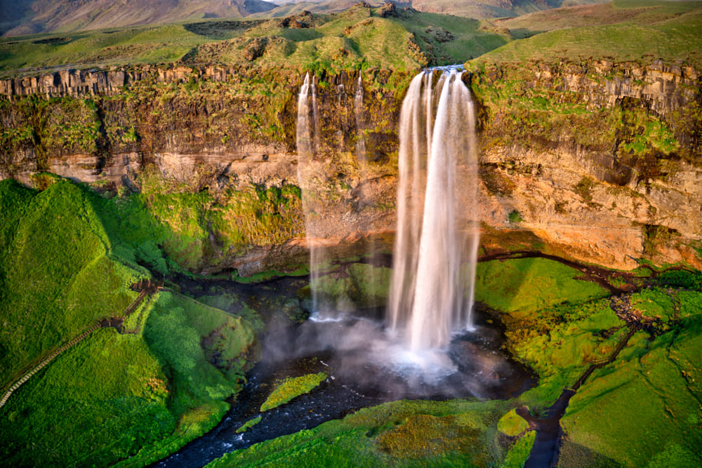 Seljandsfoss invites you to walk behind the waterfall and truly immerse yourself in the beautiful nature in Iceland