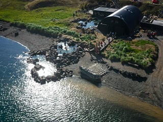 An aerial overview of the Hvammsvik Hot Springs, highlighting it´s beautiful location