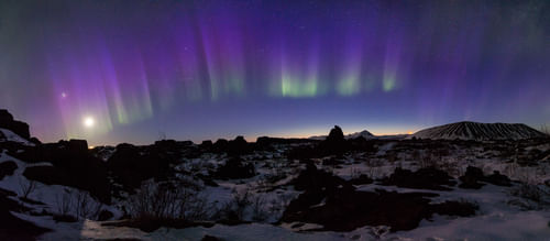 Northern Lights over cliff in Iceland