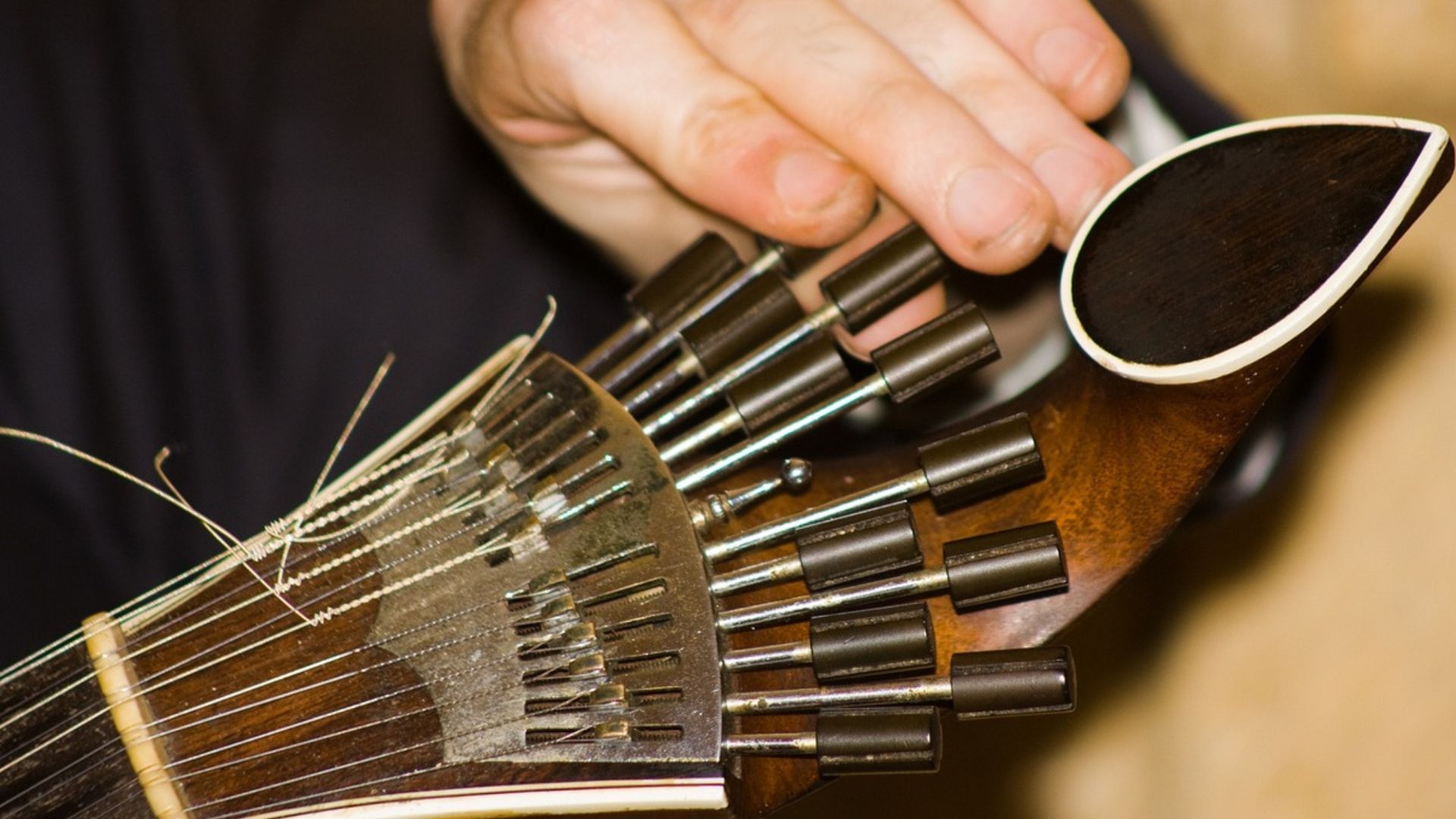 Image of a Coimbra Portuguese guitar being tuned before the Fado Show, part of Cooltour Oporto's Fado Dinner Show with Night Tour