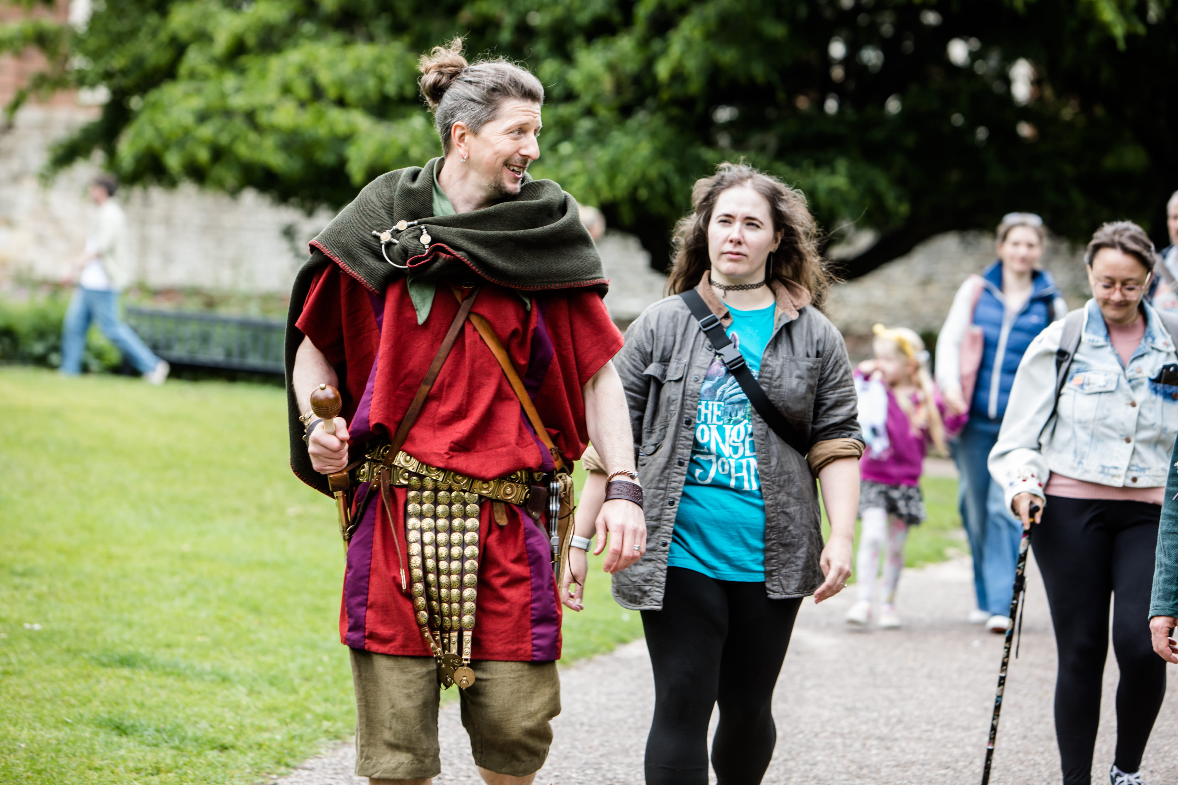 With a smile, a Roman legionary leads his tour group through the Museum Gardens in York.