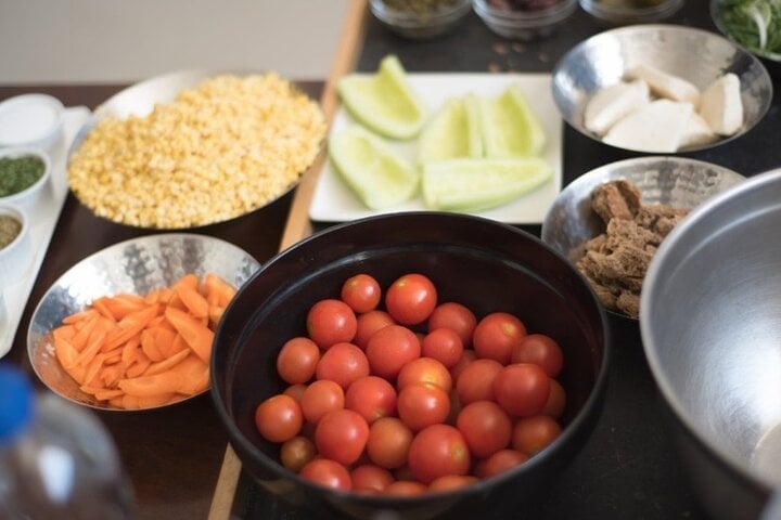 Tomatoes, split peas and vegetables prepared for a cooking lesson