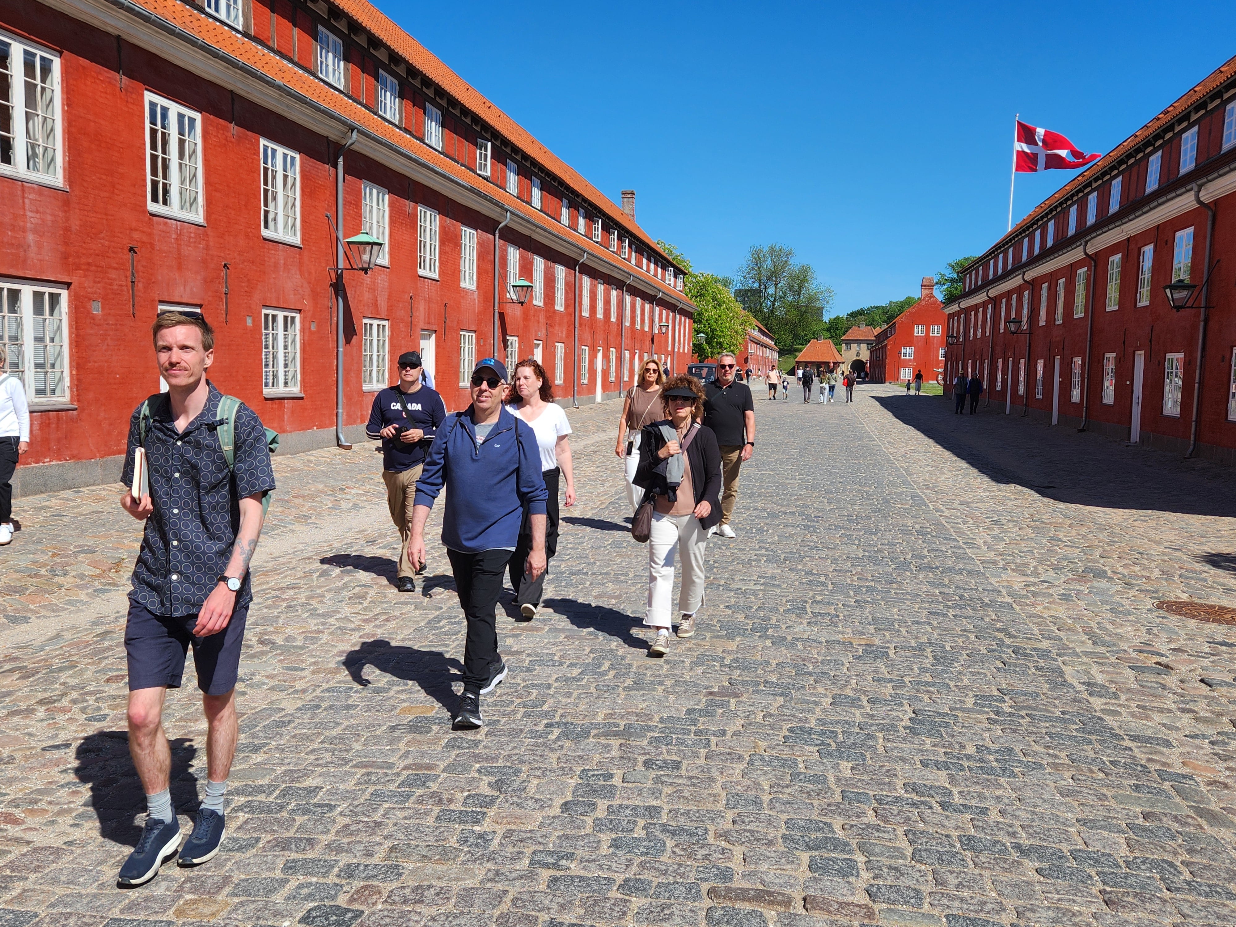 Local guide taking a small group of turist through kastellet