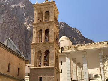 Explore the iconic stone bell tower and ancient architecture of St. Catherine’s Monastery, nestled at the foot of Mount Sina