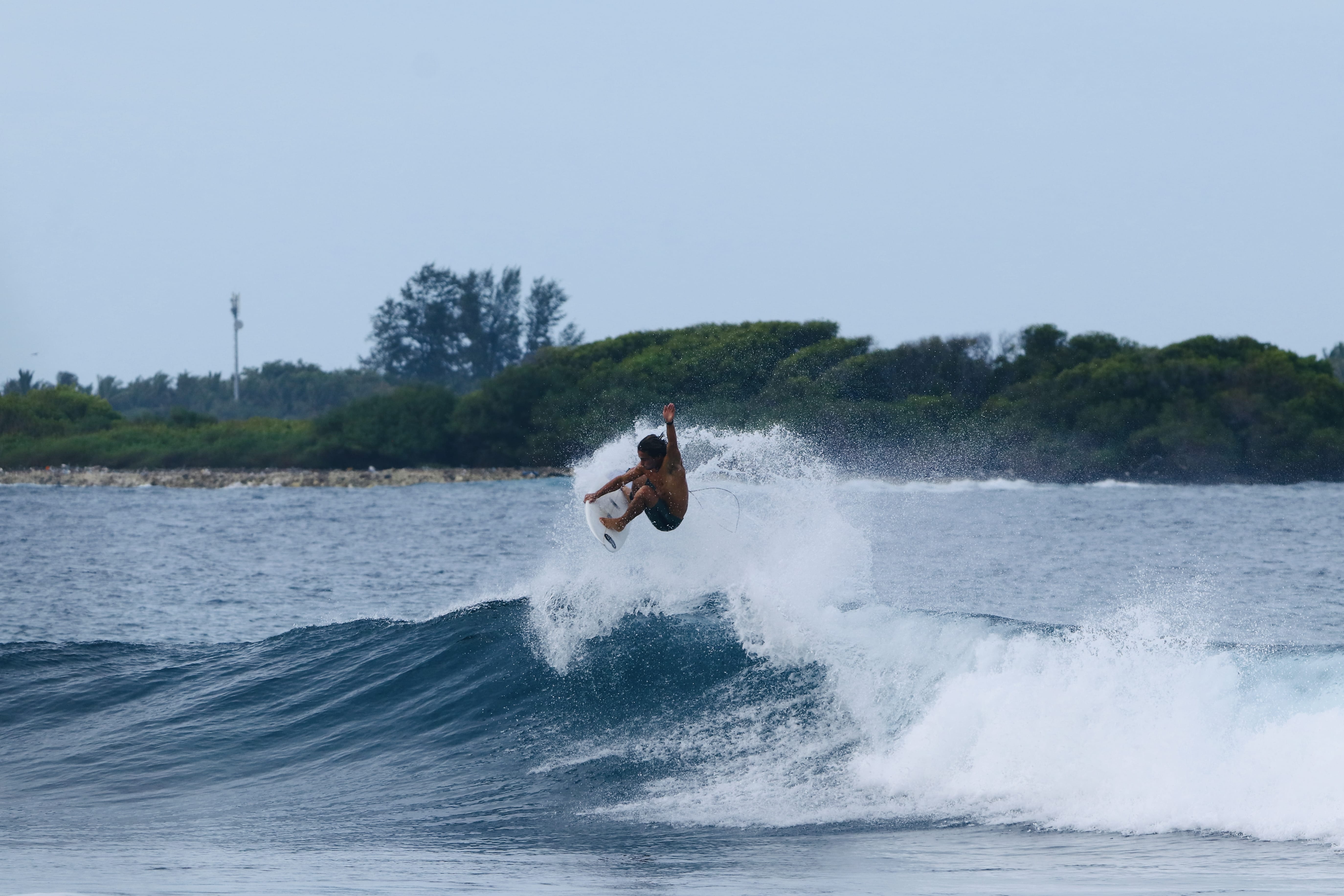 Surfer enjoying the waves at Sultans, Himmafushi Island