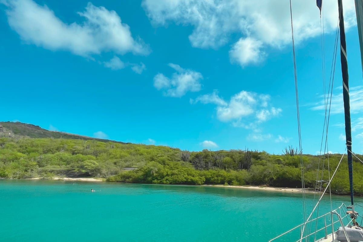 Sailing yacht Galaxie anchored in blue waters of beautiful Fuik Bay in Curacao