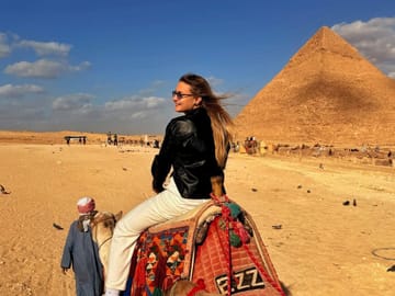 Guest riding a camel near the Great Pyramid