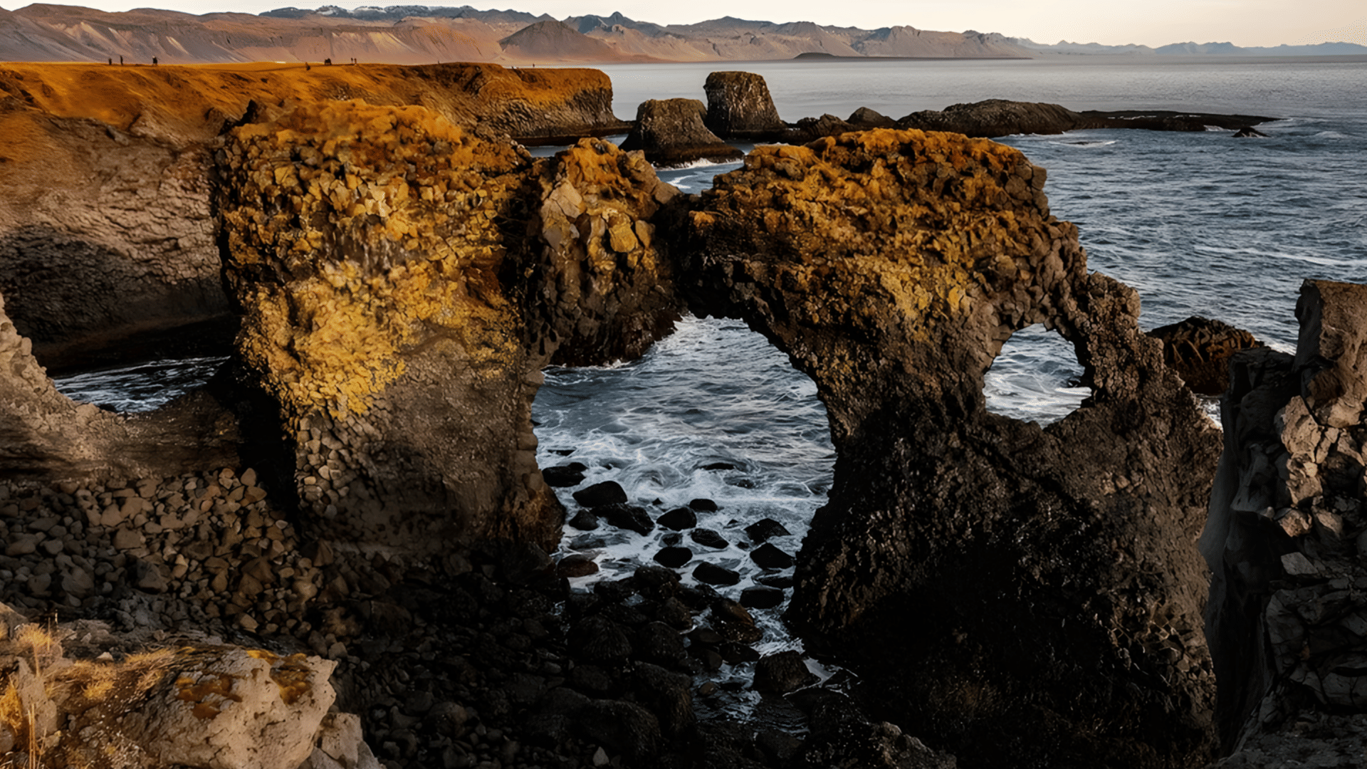 Coastal view of basalt rock formations and waves crashing into the shore below