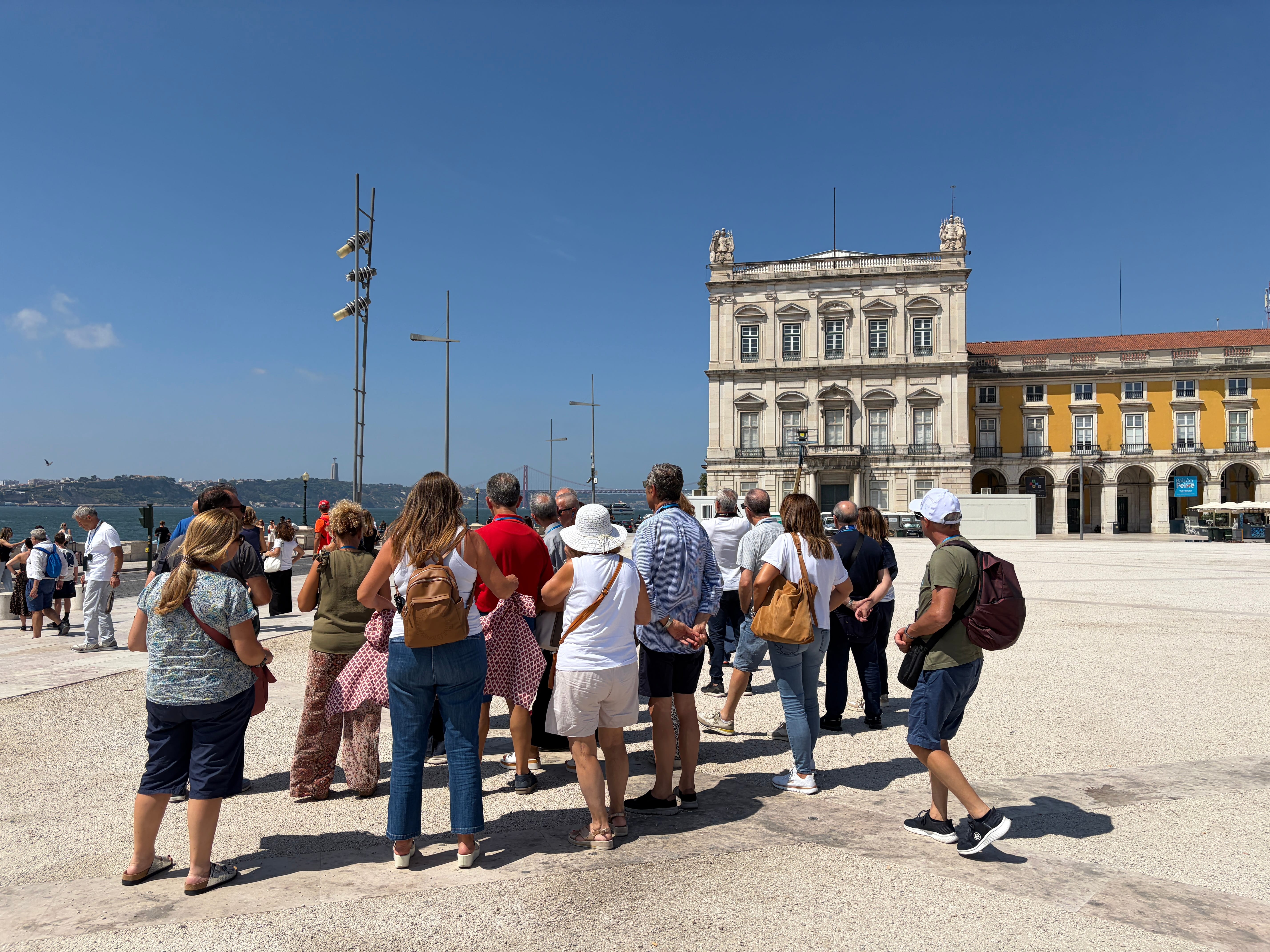 A private tour group visiting the historic Belem Tower by the Tagus River in Lisbon