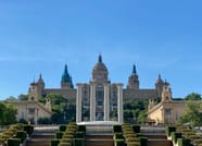 An impressive palace like building with four columns in front of it