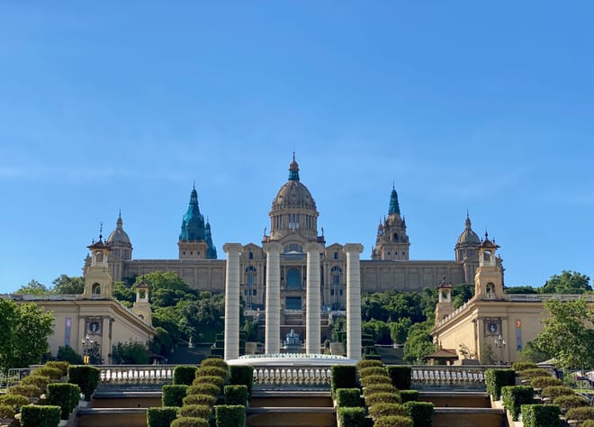 An impressive palace like building with four columns in front of it