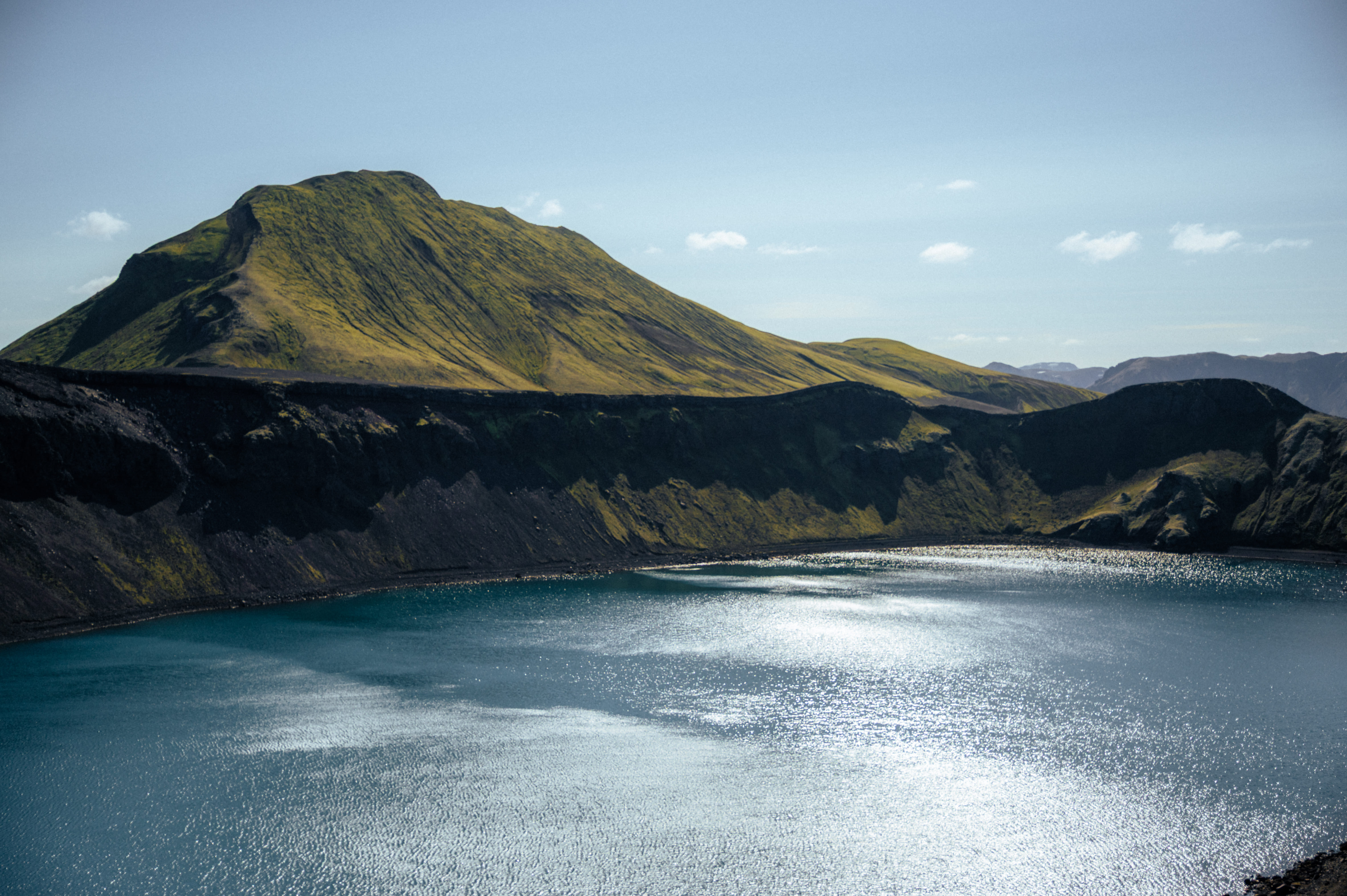 Serene blue highland lake surrounded by volcanic mountains on the route to Landmannalaugar