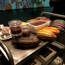 Cocoa pods, beans and nibs are displayed on a table