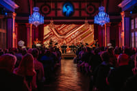 Chamber ensemble performing live classical concert Vienna with architectural projection backdrop