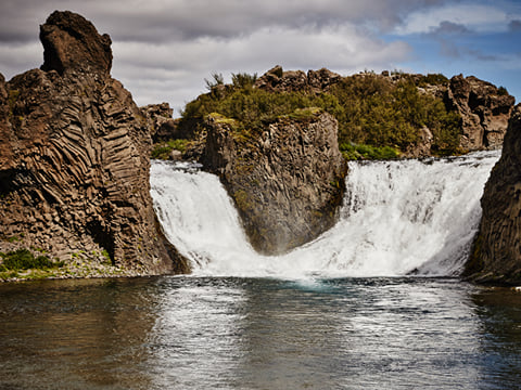Hjálparfoss, a unique double waterfall framed by lava formations