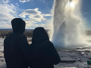 A couple gazing at the eruption of the geyser Strokkur