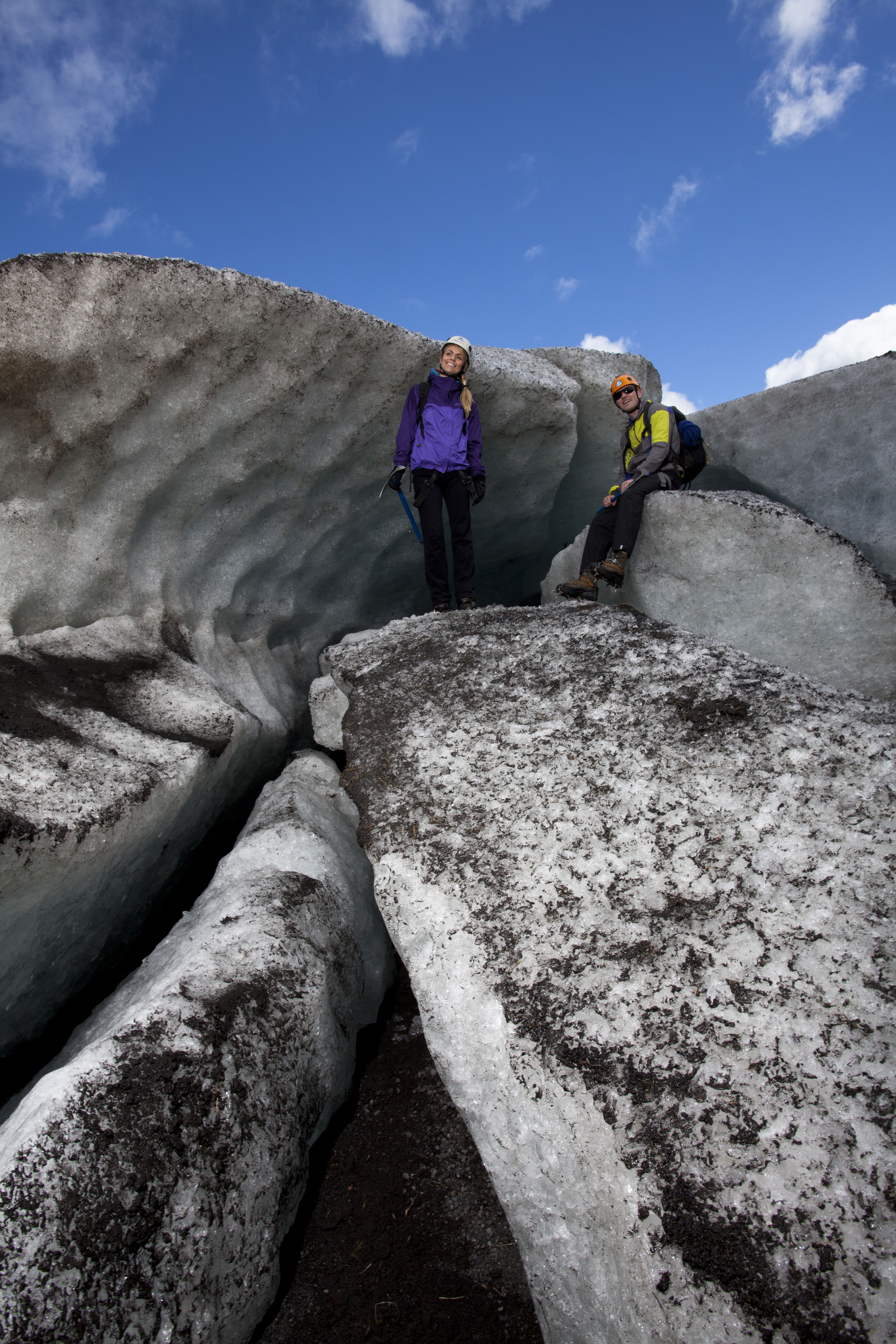 Couple of hikers posing next to the glacier