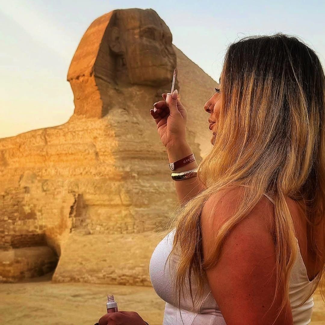 Tourists admiring the Sphinx up close, taking photos and enjoying a VIP private tour at the Giza Plateau.