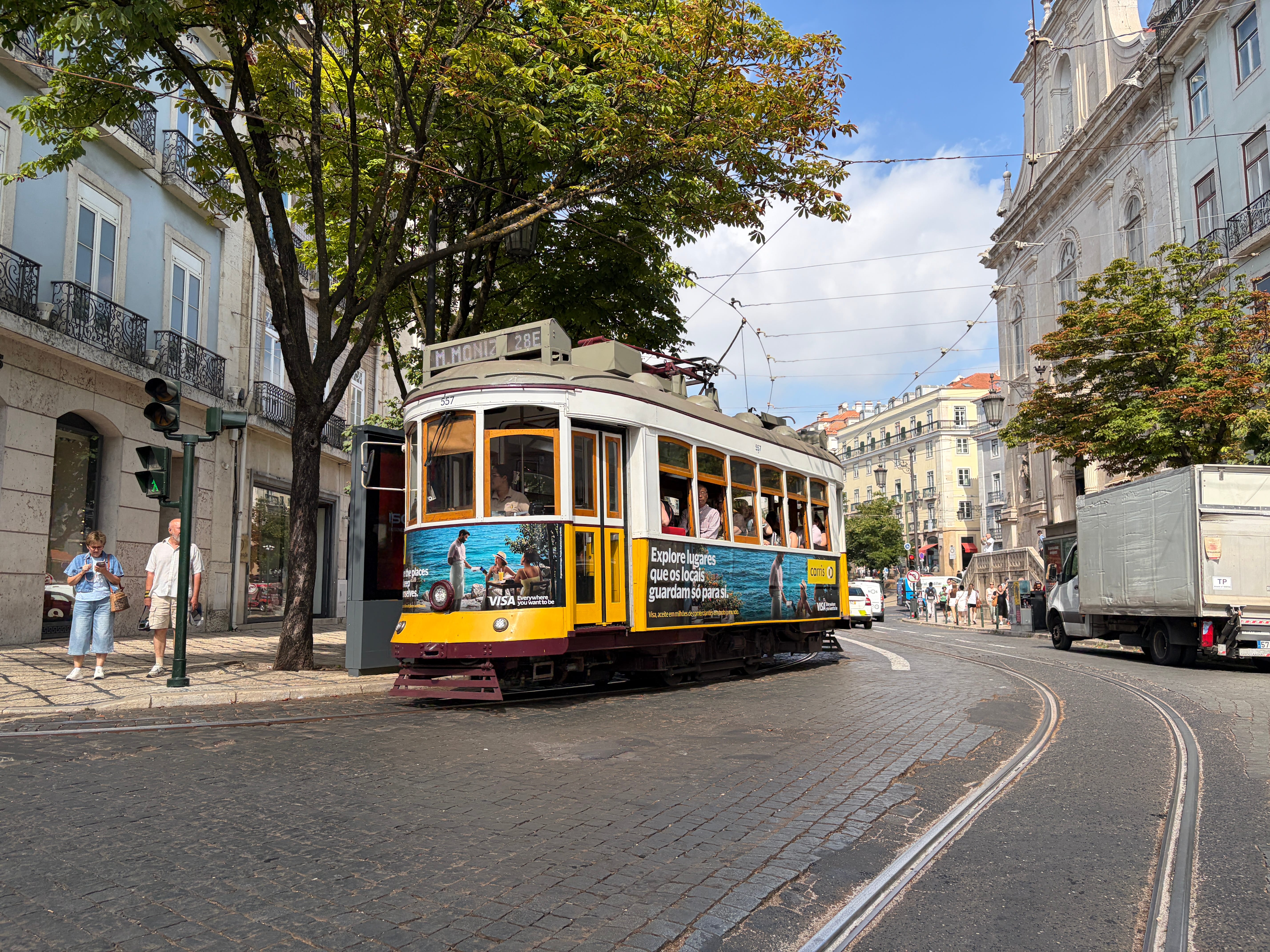 The famous yellow Tram 28 passing through the old neighborhoods of Lisbon